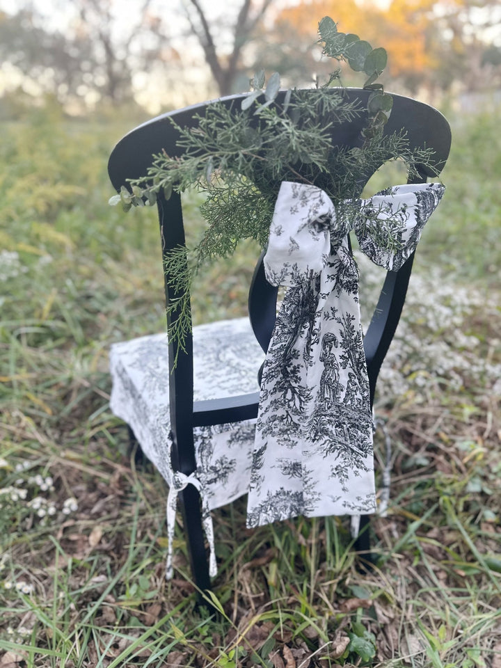 Black and white toile bow on the back of a dining chair, styled for Christmas dinner