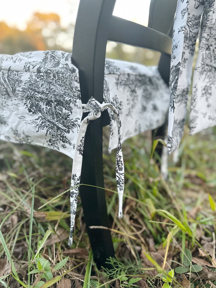 Close-up of the small toile ties knotted around the back chair leg to hold the slipcover in place