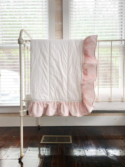White and baby pink ruffled baby crib quilt in washed cotton, about 34 by 42 inches