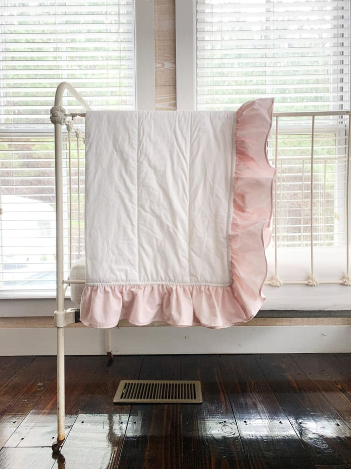 White and baby pink ruffled baby crib quilt in washed cotton, about 34 by 42 inches