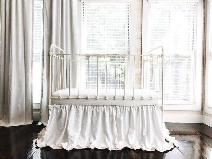 White and baby pink ruffled crib skirt in washed cotton, 22-inch drop, gathered