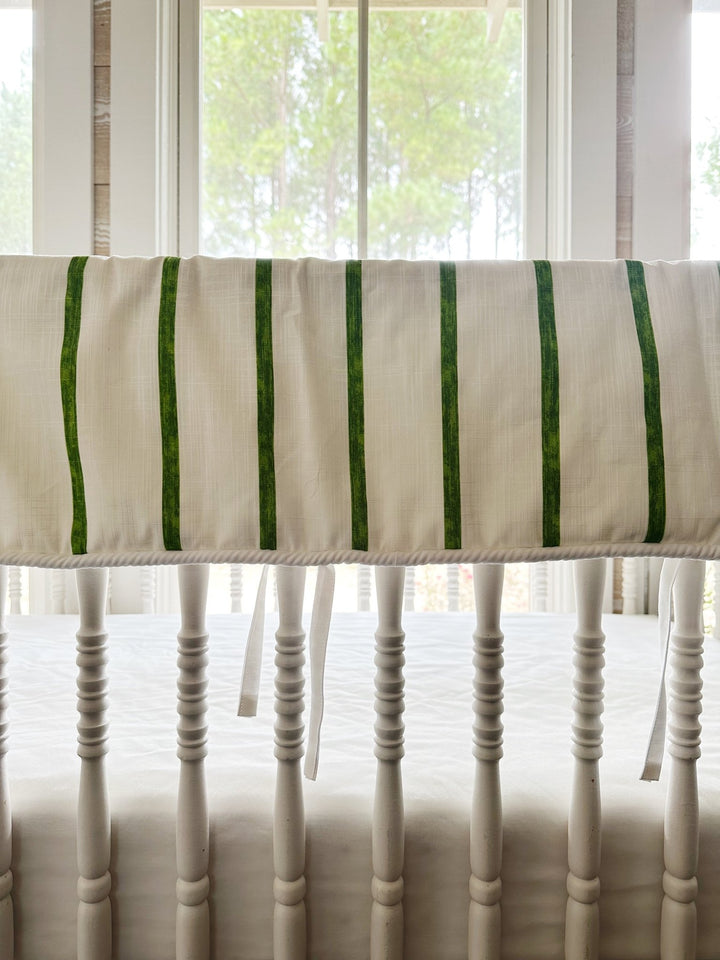 Close view of the painted green stripes, the white cording along the bottom edge and one slim white tie
