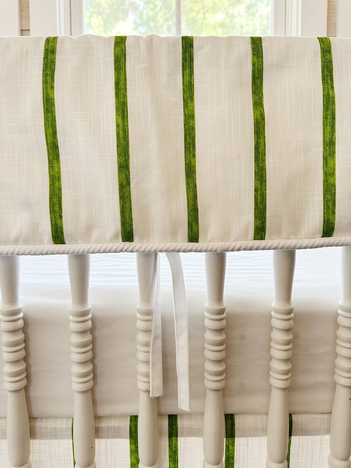 Close view of the brushed green stripes, the white cording along the bottom edge and one slim white tie