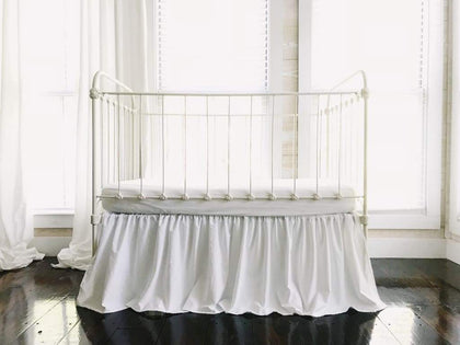 White farmhouse crib skirt in washed cotton, 20-inch drop with split corners