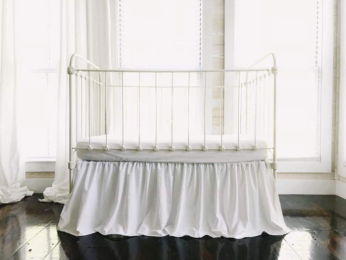 White farmhouse crib skirt in washed cotton, 20-inch drop with split corners