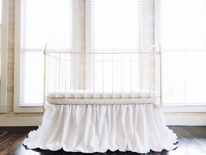 White ruffled crib skirt in washed cotton, 22-inch drop, gathered on all four sides