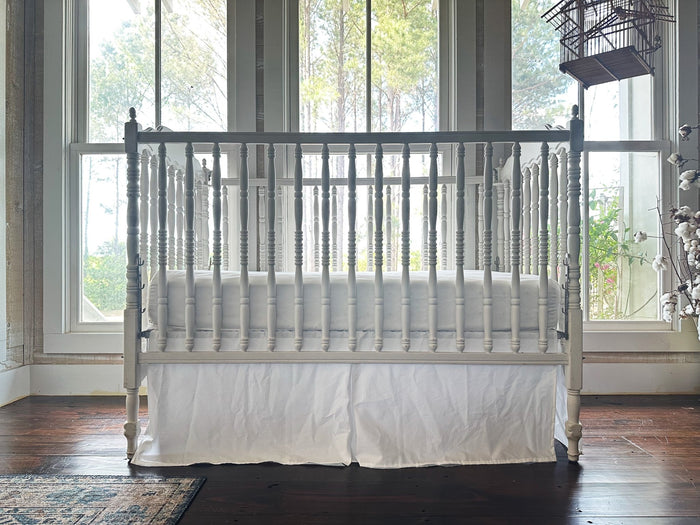 White tailored crib skirt in washed cotton