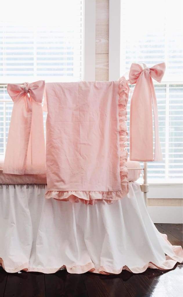 Ballet slipper pink crib blanket with a matching ruffle border in washed cotton