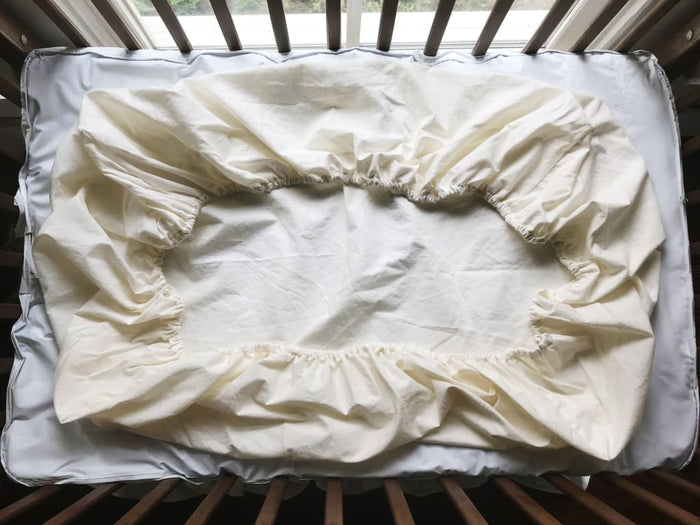 Ivory fitted mini crib sheet in washed cotton, 24 by 38 inches