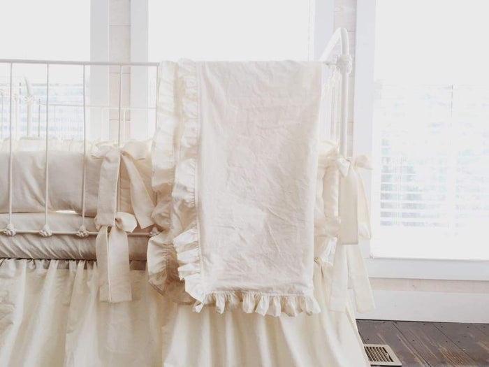 Ivory ruffled baby crib blanket in washed cotton, about 34 by 42 inches