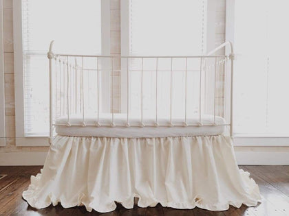 Ivory ruffled crib skirt in washed cotton, 22-inch drop, gathered on all four sides