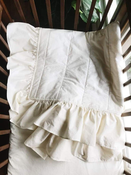 Ivory ruffled handmade baby quilt in washed cotton, about 34 by 42 inches