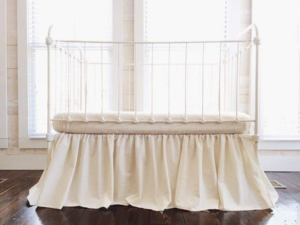Natural farmhouse crib skirt in washed cotton, 20-inch drop with split corners
