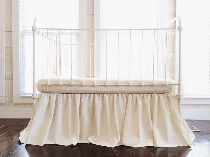 Natural farmhouse crib skirt in washed cotton, 20-inch drop with split corners